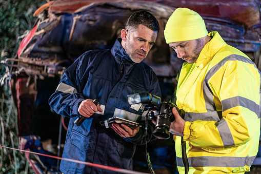 Investigating police officer are inspecting the crash site