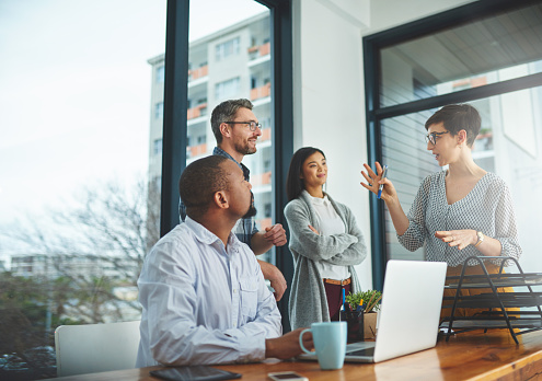 Cropped shot of a group of colleagues having a discussion in a modern office